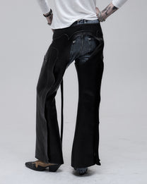 Riding Chaps in black leather, back view on model, worn over jeans