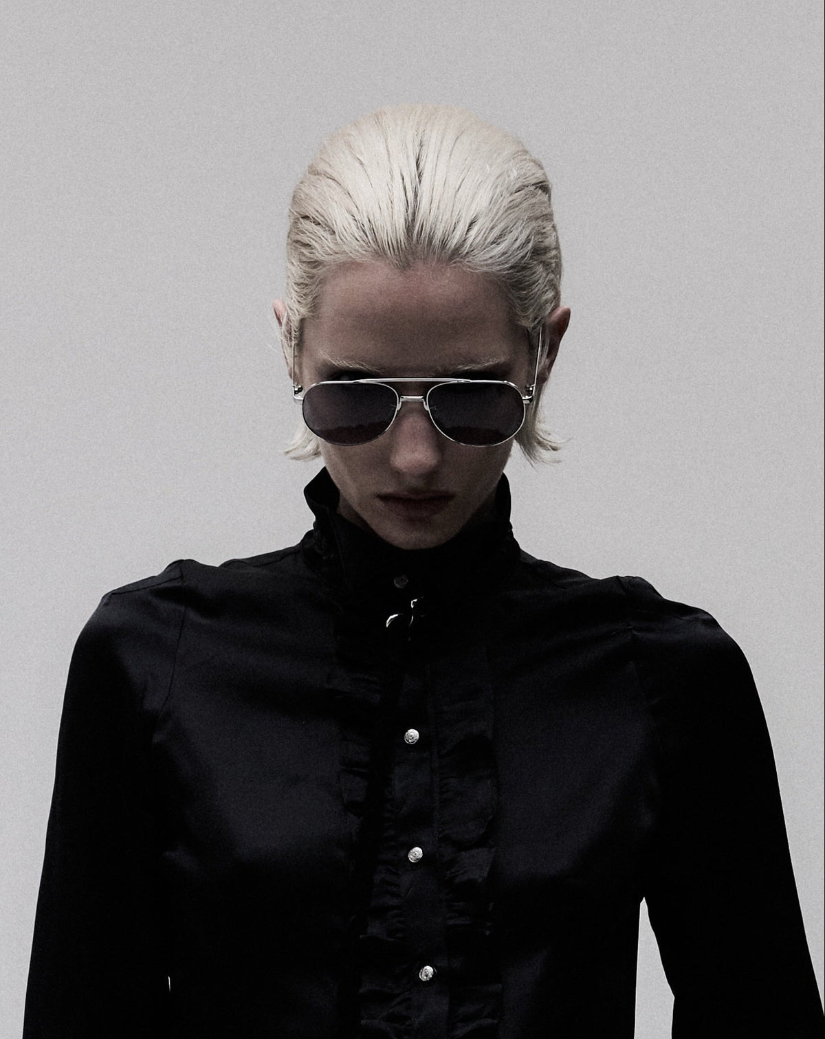Aviator 001 sunglasses with silver frame and blue lenses, worn on model