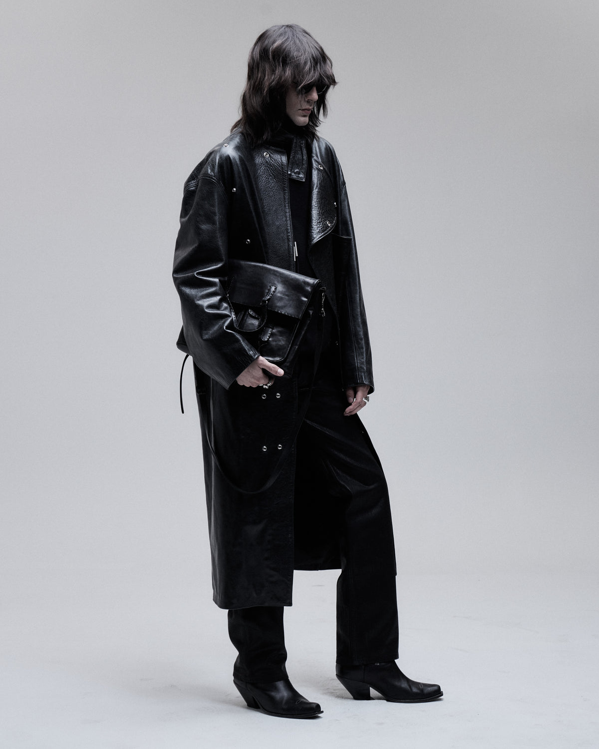 Jeffrey Coat asymmetric leather overcoat in black, three-quarter view on model