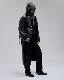 Jeffrey Coat asymmetric leather overcoat in black, three-quarter view on model