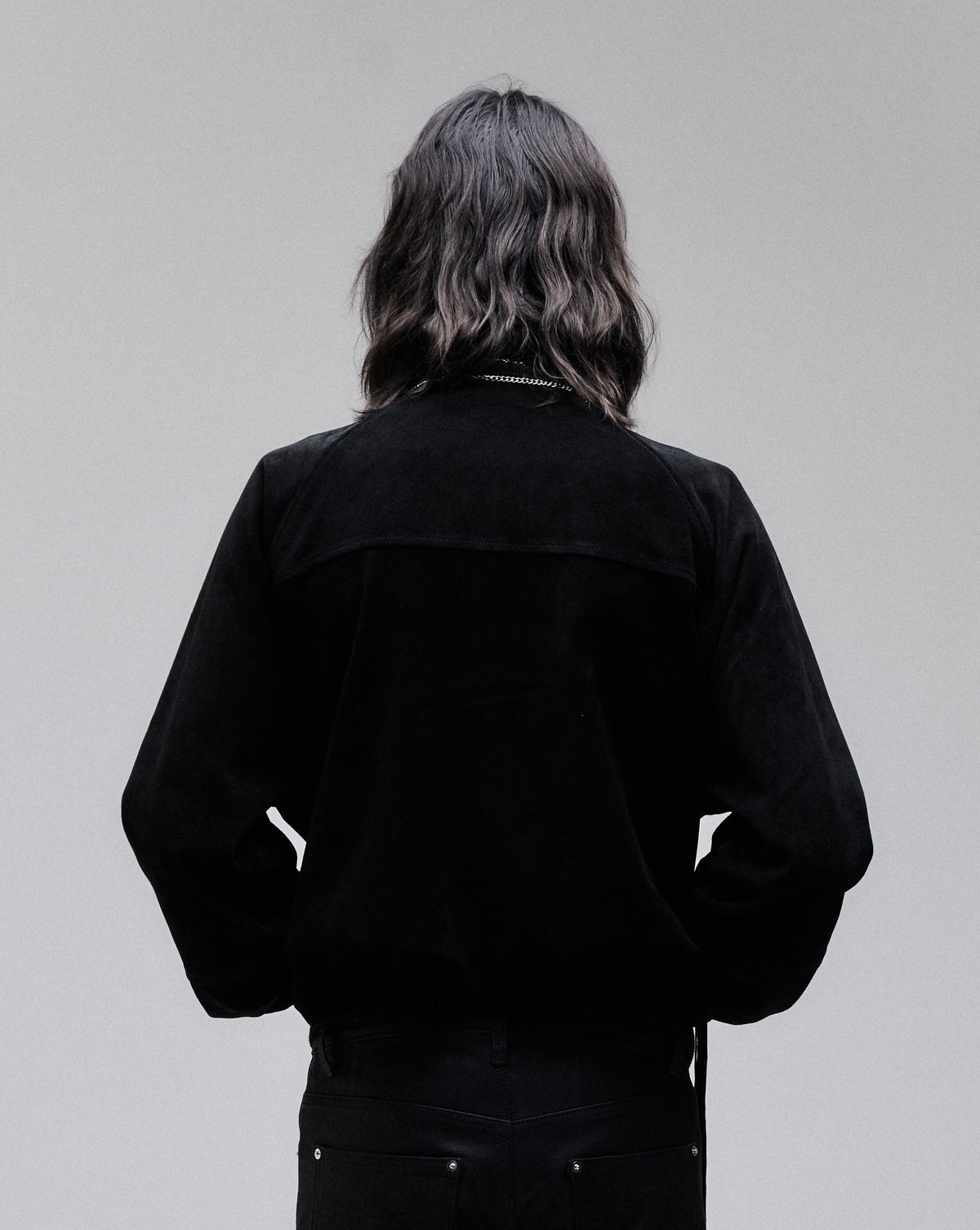 Suede Bomber jacket in black, back view on model