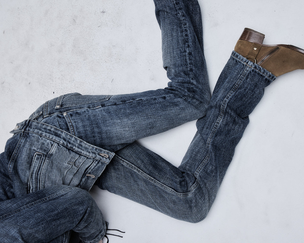 Hollywood Low-Rise jean in washed blue, worn by a reclining model
