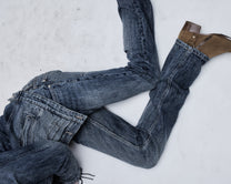 Hollywood Low-Rise jean in washed blue, worn by a reclining model