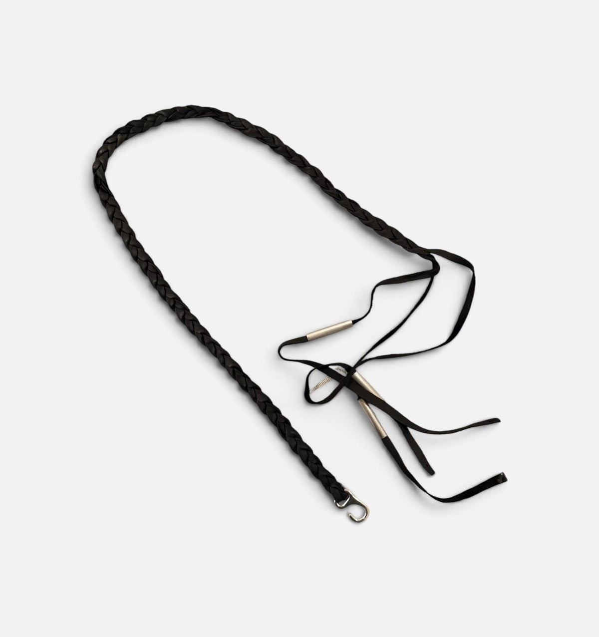 Tassel necklace in black leather and silver, flat lay